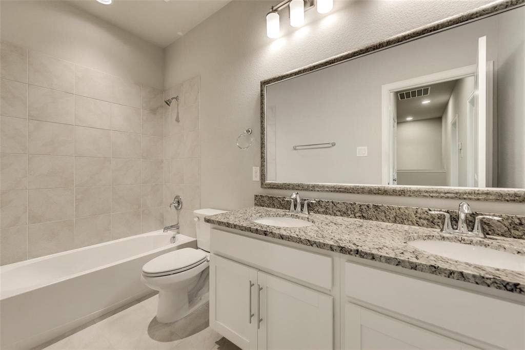 Double vanity with granite countertop, undermount sinks, and chrome fixtures