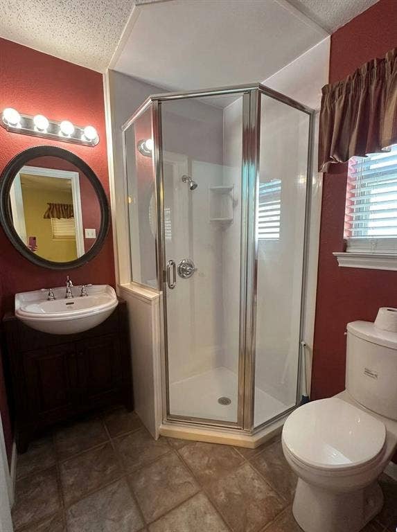 Offers updated shower with glass enclosure, commode and sink/cabinet and mirror, lighting.
