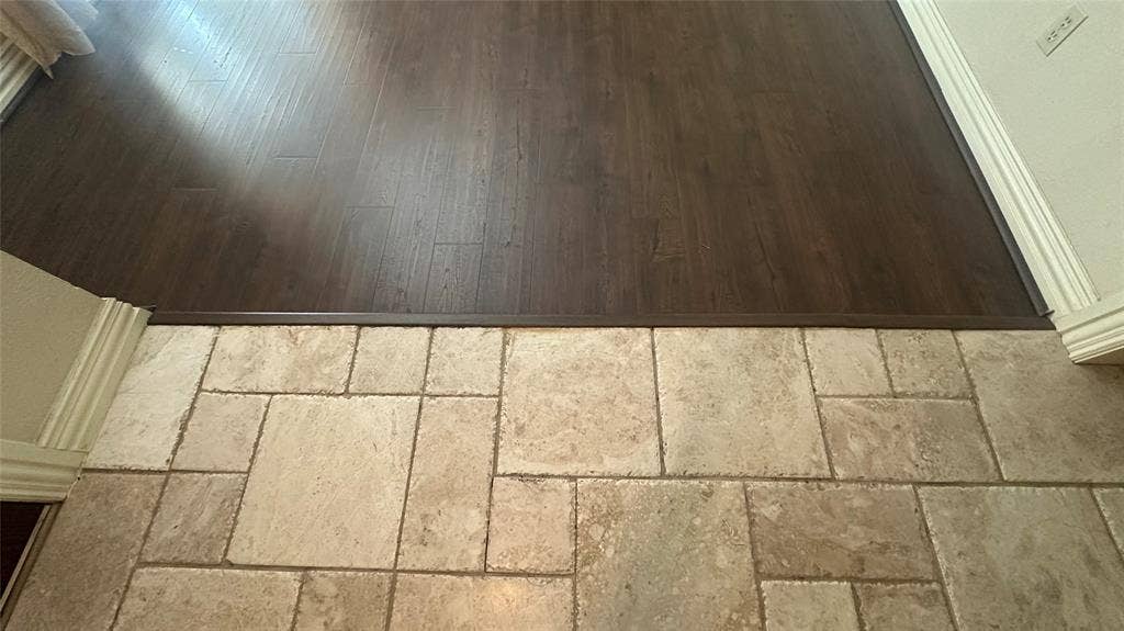 Wood-finish flooring throughout the formal LR-DR, Hallway and middle bedroom.  Entry is pretty tile of multiple size, neutral colors.