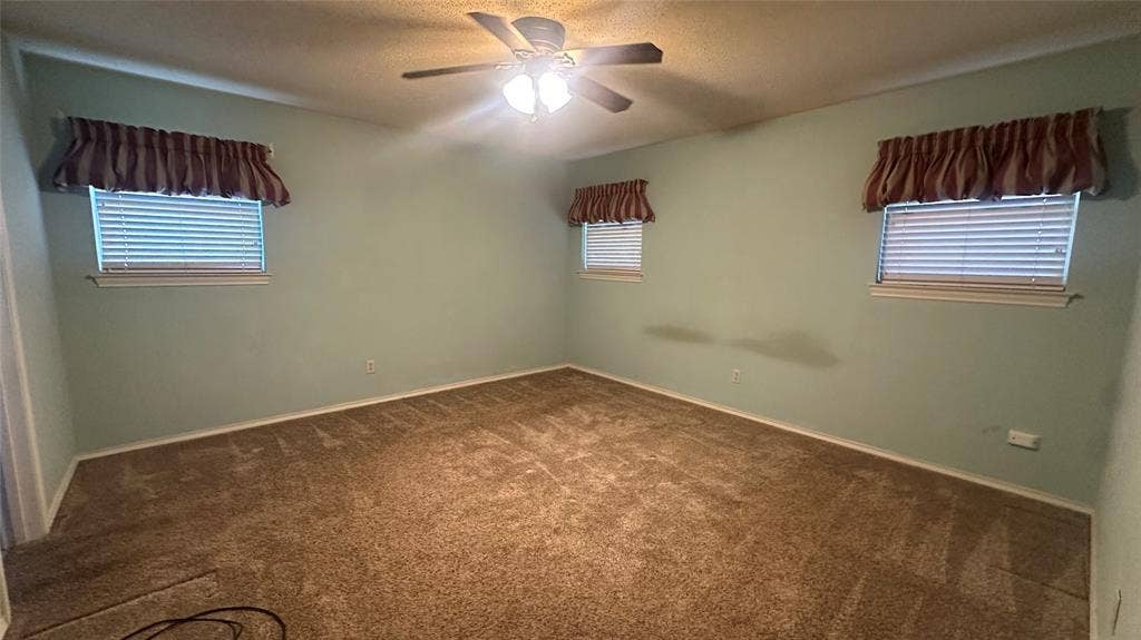Unfurnished view of primary BR, Carpeted room with a ceiling fan