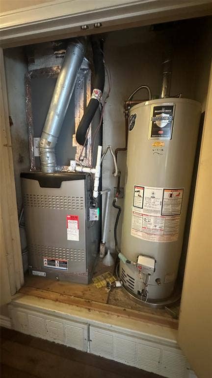 HVAC and water heater with drain pan, located in hall closet.  Both updated, not original and services HVAC twice a year.