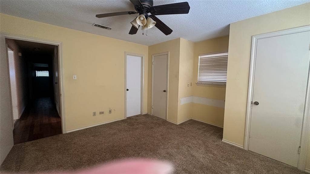 View 2 unfurnished of front BR.  Corner door is direct access to Hall bathroom.