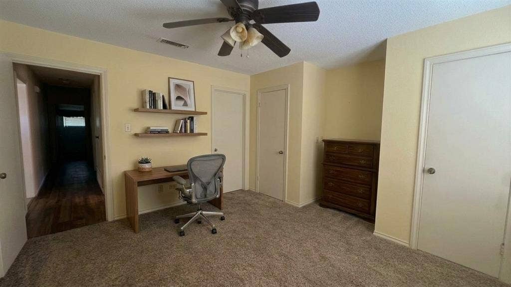 Staged AI furniture;  Ceiling fan, carpet, two panel closet doors, and direct access to bathroom.
