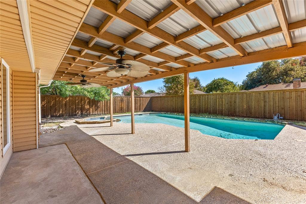 2716 Landershire Lane, Plano, TX 75023 Covered patio with exposed wood framing, two ceiling fans, and a metal roof