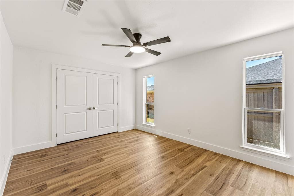 2716 Landershire Lane, Plano, TX 75023 Wood-finish flooring, white walls, and a ceiling fan with integrated lighting