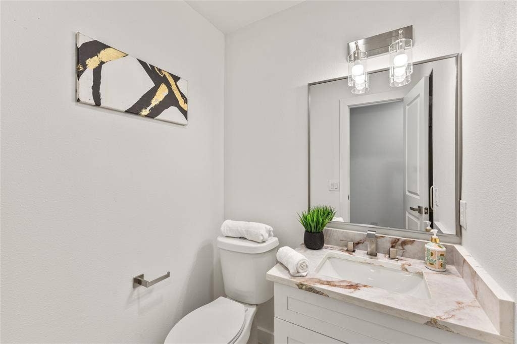 2716 Landershire Lane, Plano, TX 75023 White vanity with an integrated sink and stone countertop