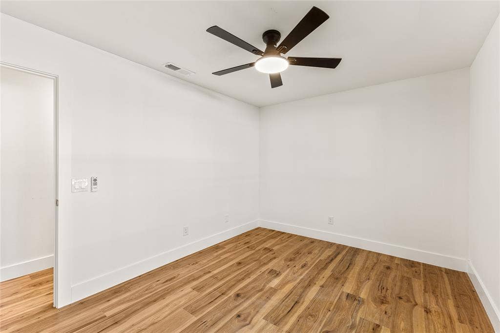 2716 Landershire Lane, Plano, TX 75023 Wood-finish flooring with white walls and a ceiling fan with integrated lighting