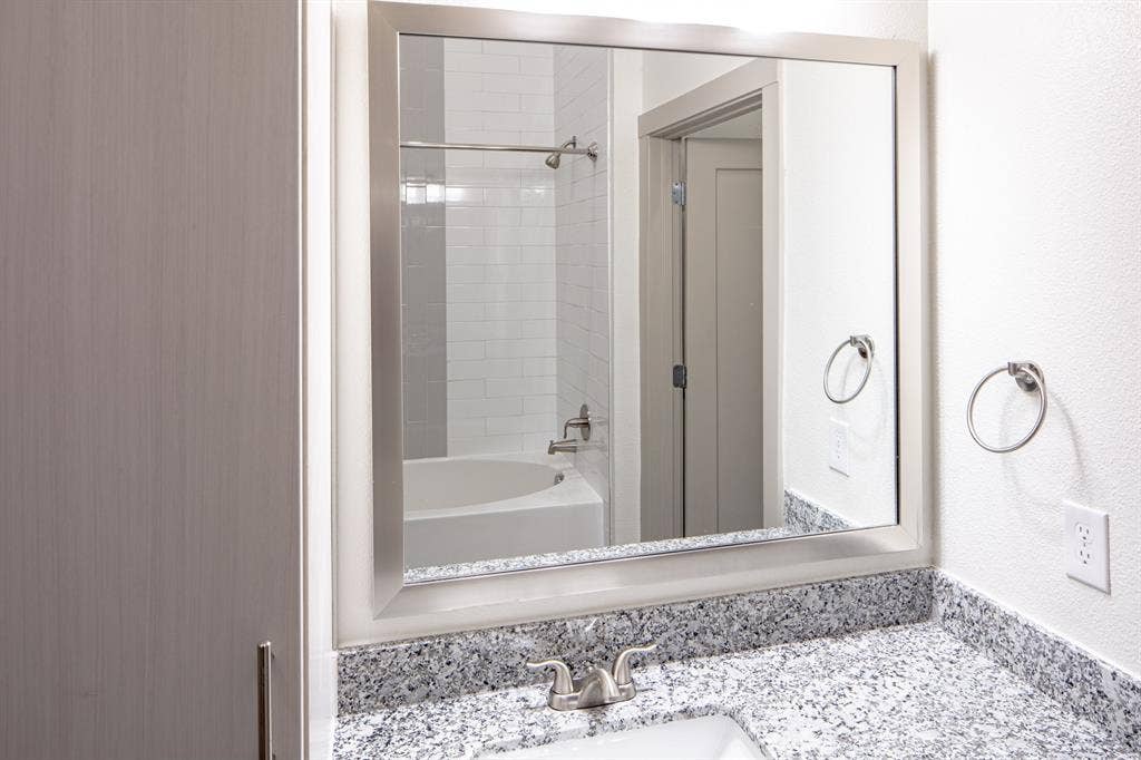 601 N Oak Street, #118, Roanoke, TX 76262 Bathroom with tiled shower / bath combo and vanity