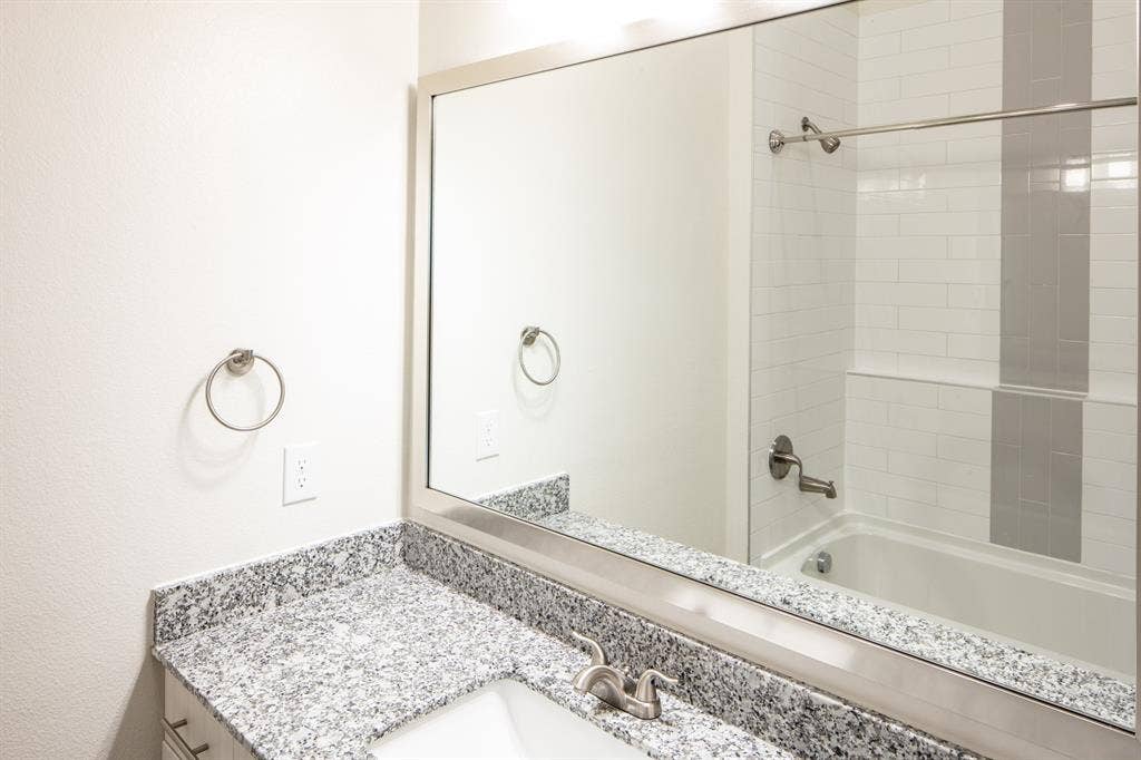 601 N Oak Street, #118, Roanoke, TX 76262 Bathroom with vanity and tiled shower / bath combo