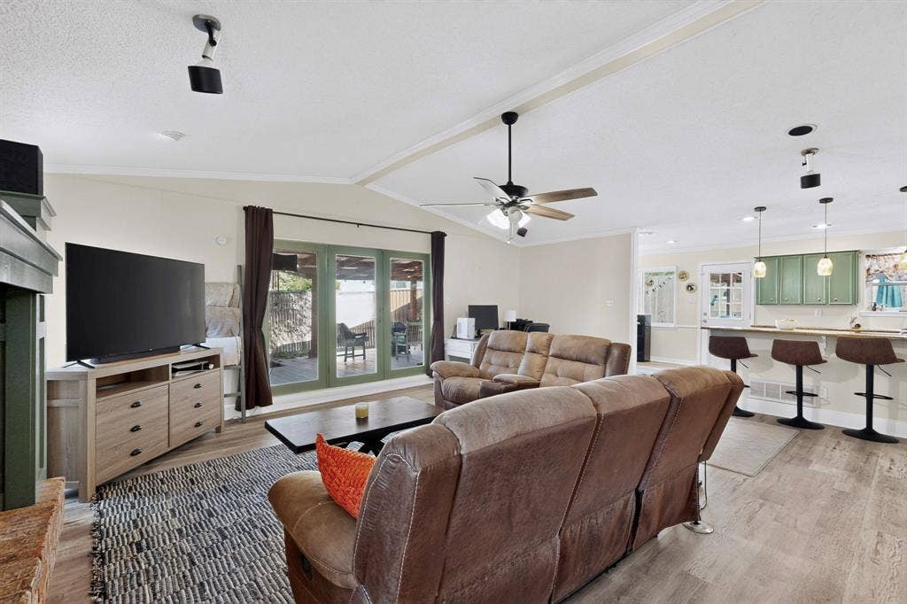 1418 Stony Brook Lane, Garland, TX 75043 Vaulted ceiling with a ceiling fan, recessed lighting, wood-finish flooring, and French doors leading to an outdoor patio