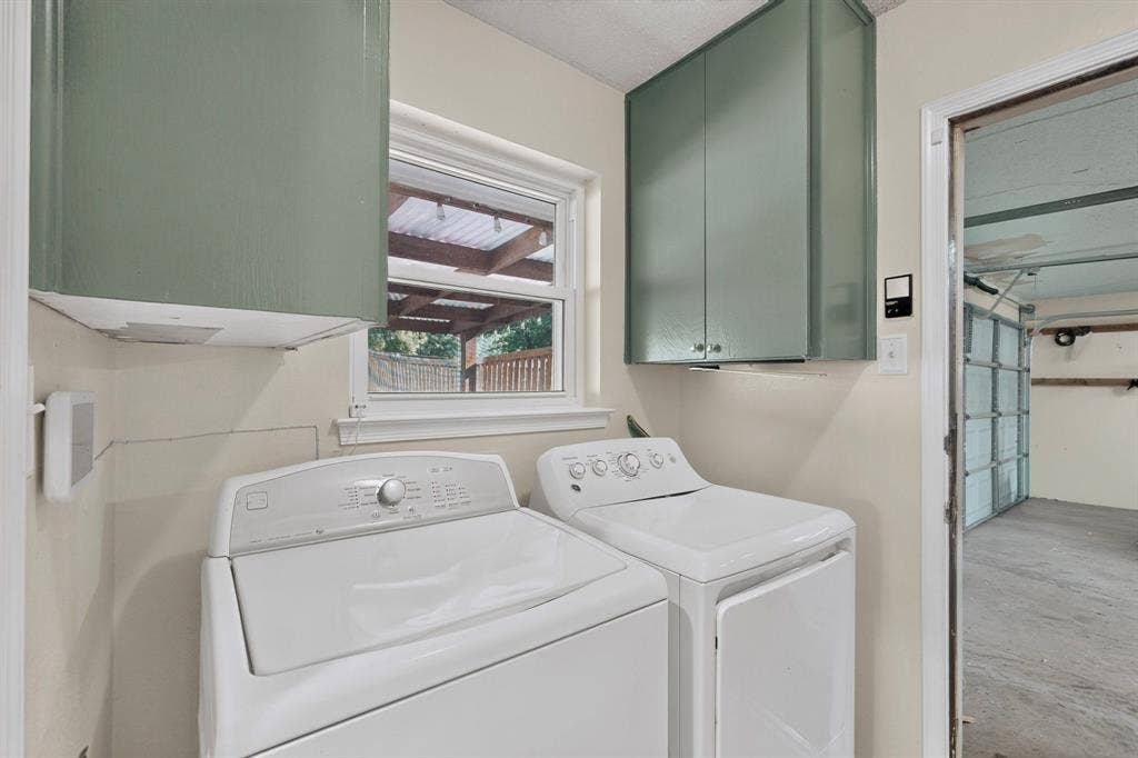 1418 Stony Brook Lane, Garland, TX 75043 Utility area featuring light green upper cabinetry and a window with natural light