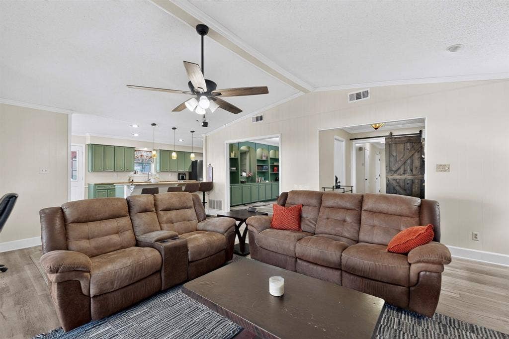 1418 Stony Brook Lane, Garland, TX 75043 Vaulted ceiling with exposed beam, wood-finish flooring, recessed lighting, ceiling fan, and a built-in barn door