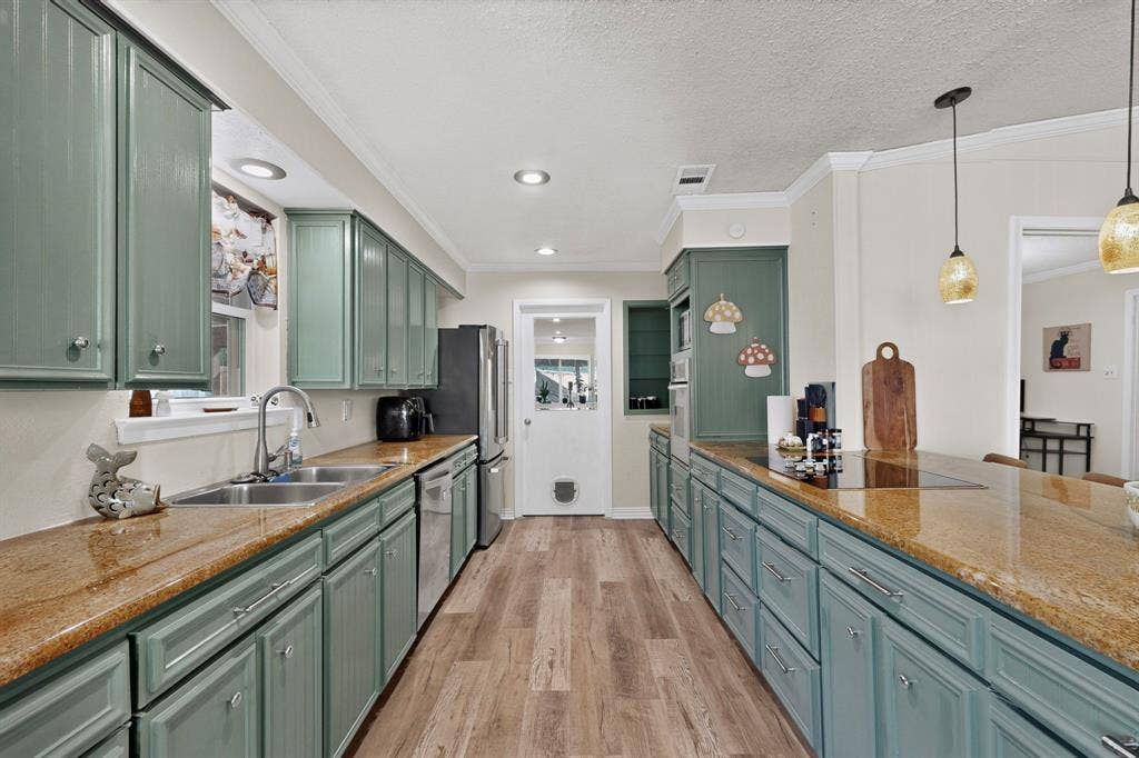 1418 Stony Brook Lane, Garland, TX 75043 Spacious kitchen featuring extensive cabinetry, stone-finish countertops, wood-finish flooring, and recessed lighting