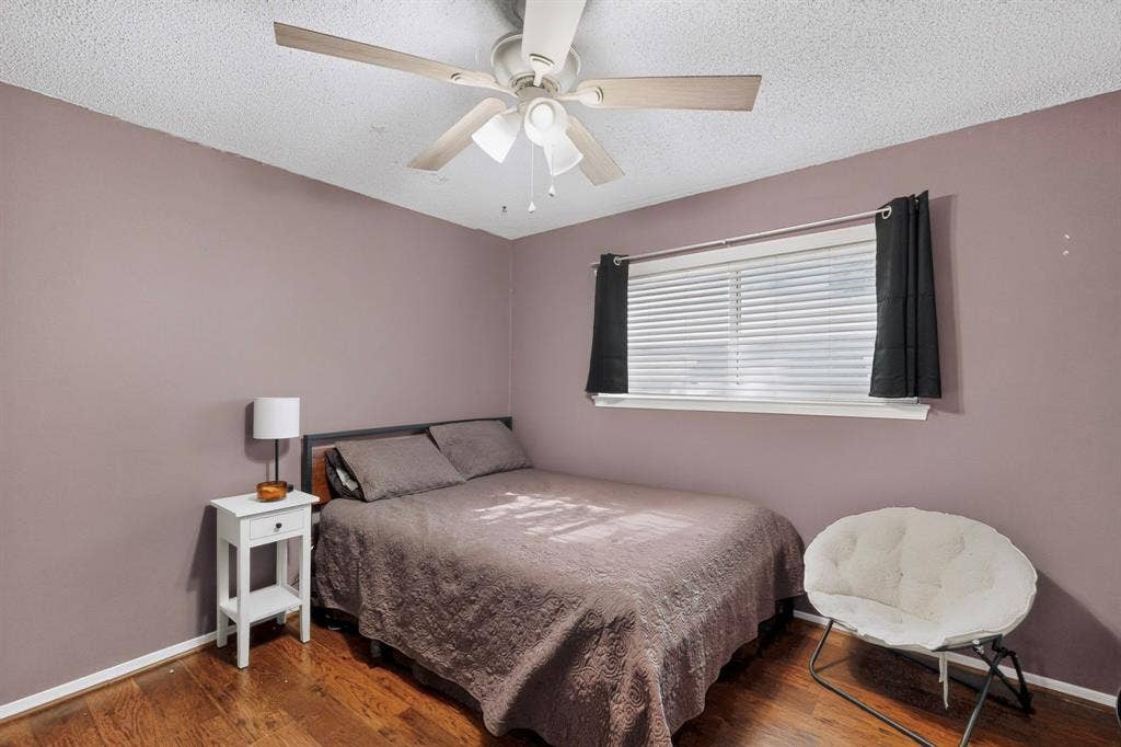 1418 Stony Brook Lane, Garland, TX 75043 Wood-finish flooring, ceiling fan with light fixture, window with blinds, and painted walls