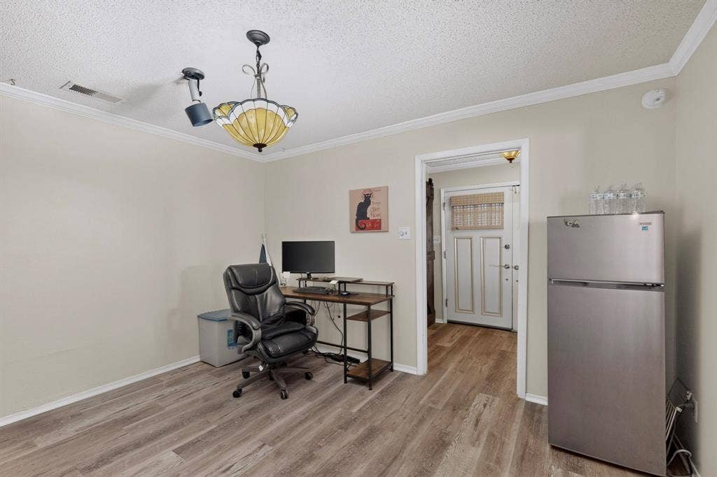 1418 Stony Brook Lane, Garland, TX 75043 Wood-finish flooring, crown molding, and a decorative ceiling fixture