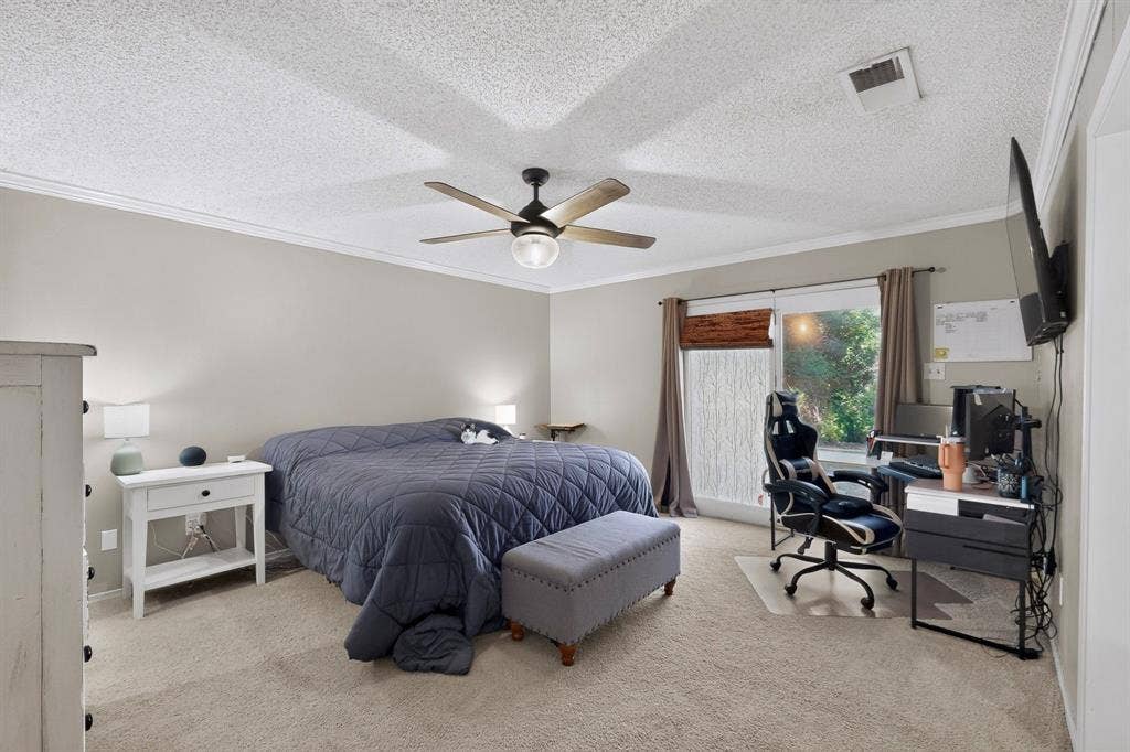 1418 Stony Brook Lane, Garland, TX 75043 Light-filled interior featuring neutral wall tones, crown molding, and carpet flooring