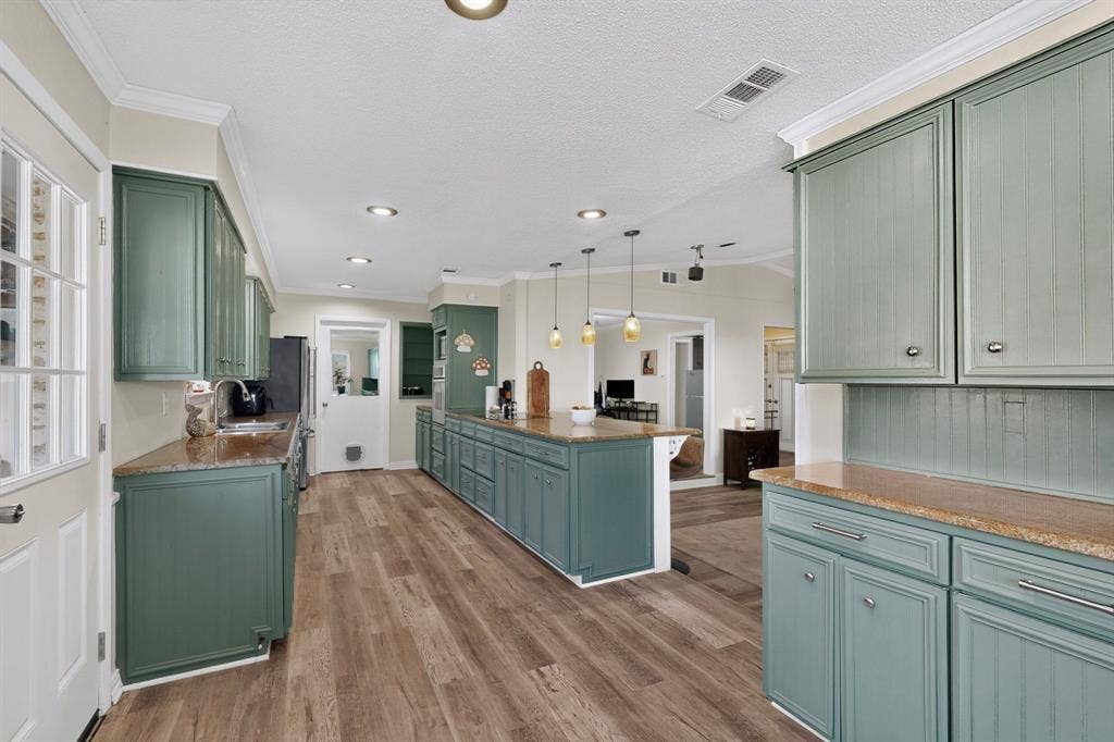 1418 Stony Brook Lane, Garland, TX 75043 Kitchen featuring green cabinetry, granite countertops, wood-finish flooring, and recessed lighting