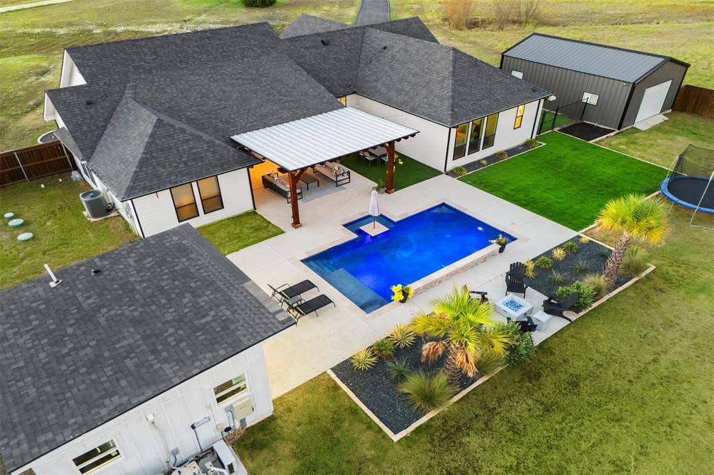 1220 Lynn Way, Waxahachie, TX 75165 The complete package: Augusta Custom Homes construction, resort-style pool, separate pool house and powered shop on 1.224 acres.