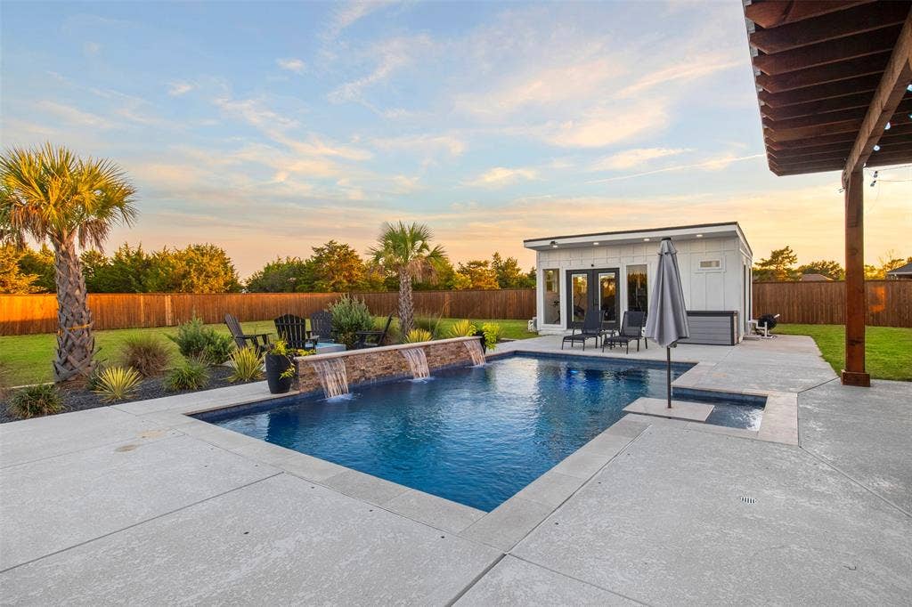 1220 Lynn Way, Waxahachie, TX 75165 Resort-style pool featuring a tanning ledge, margarita table and sheer-descent water features.