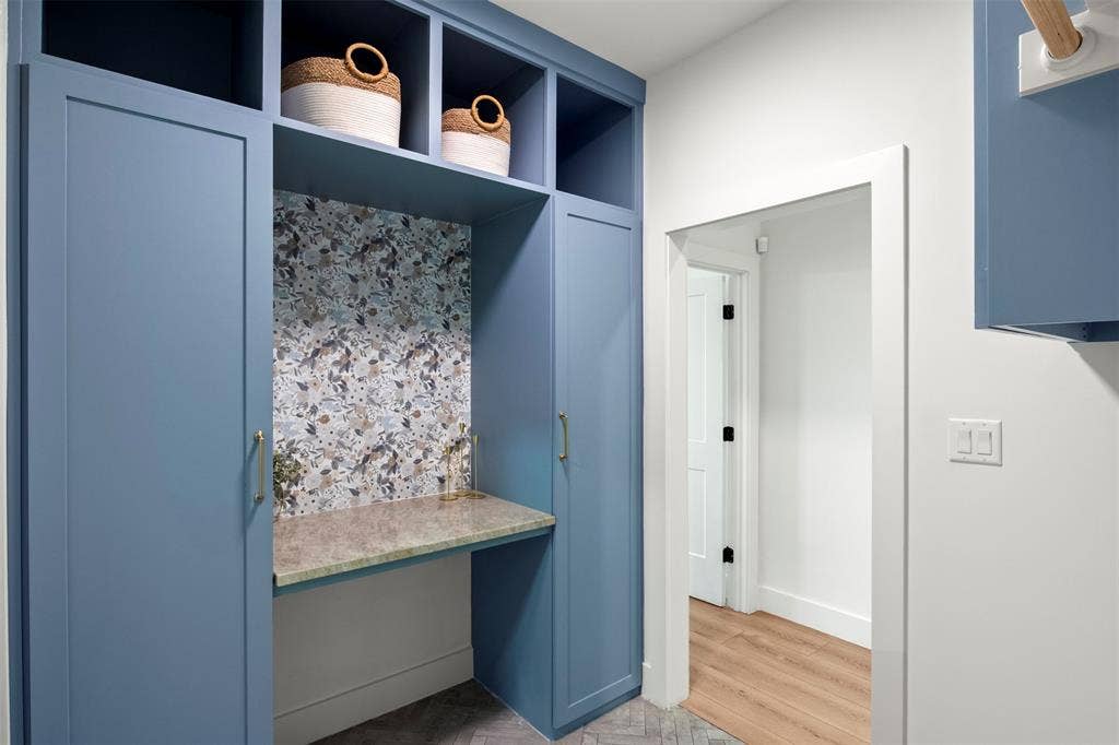 1220 Lynn Way, Waxahachie, TX 75165 Convenient direct connection between the laundry room and primary closet. Custom blue cabinetry adds style and practical storage.