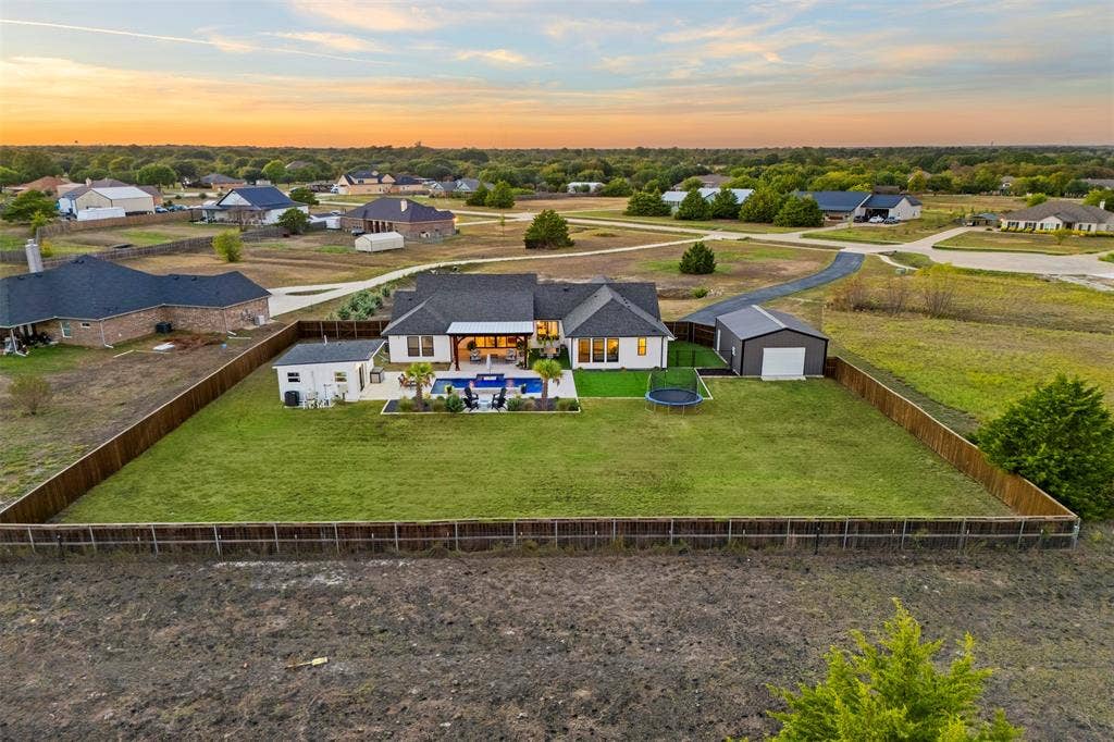1220 Lynn Way, Waxahachie, TX 75165 Aerial perspective shows the expansive fenced backyard and separation between the home, pool and shop.