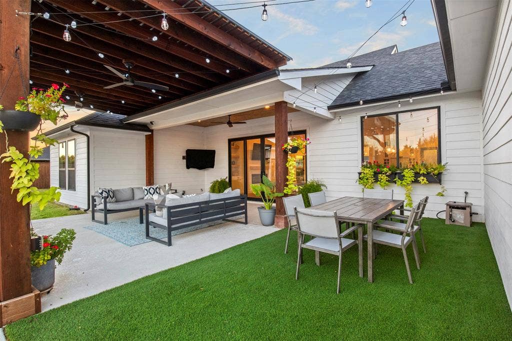 1220 Lynn Way, Waxahachie, TX 75165 Poolside entertaining is steps from the covered patio and outdoor seating areas with turf underfoot and café lighting overhead.