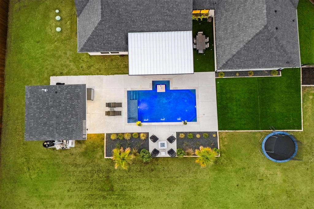 1220 Lynn Way, Waxahachie, TX 75165 A clear view of the pool, covered patio, separate pool house and backyard layout.