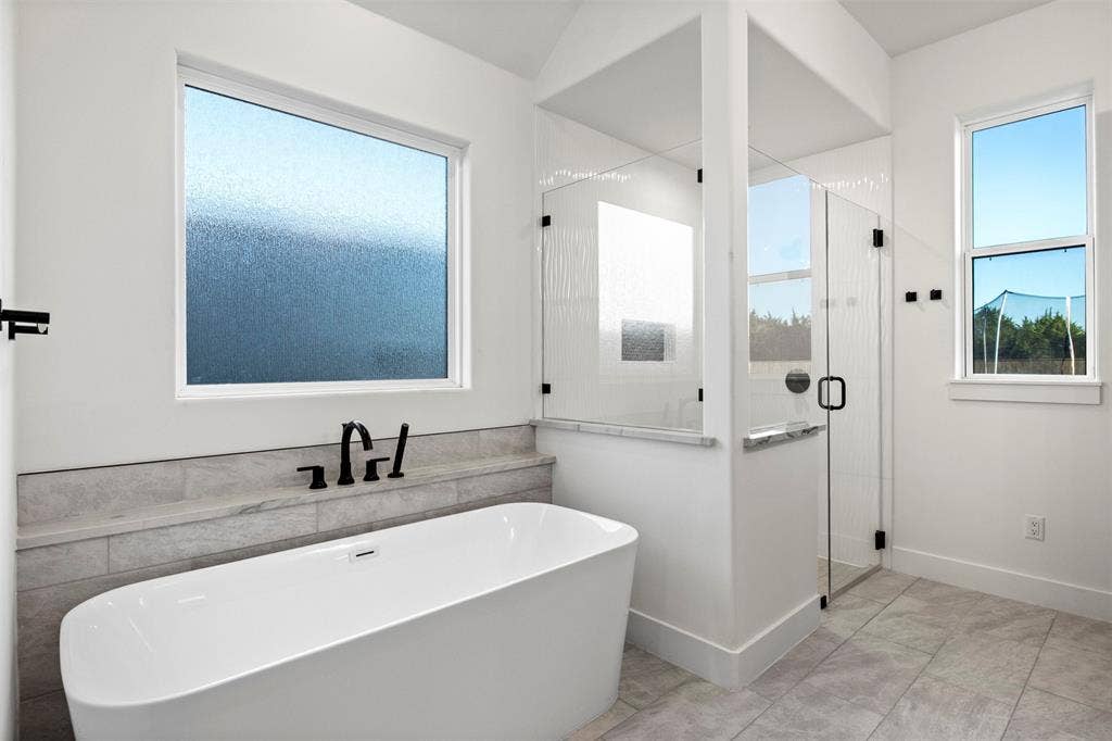 1220 Lynn Way, Waxahachie, TX 75165 Freestanding soaking tub, separate walk-in shower and abundant natural light.
