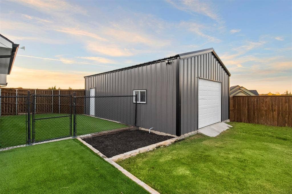1220 Lynn Way, Waxahachie, TX 75165 Separate 20Ă—30 powered shop with roll-up doors at both ends. Next to separate fenced turfed side yard for pets or play