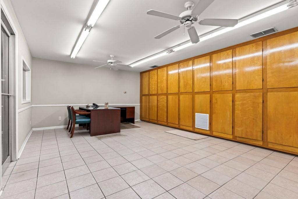 414 E Marshall Street, Gilmer, TX 75644 Tile flooring, multiple ceiling fans, extensive built-in cabinetry, fluorescent lighting, and a window