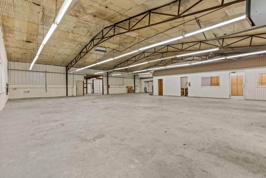 414 E Marshall Street, Gilmer, TX 75644 Expansive concrete flooring with a high trussed ceiling