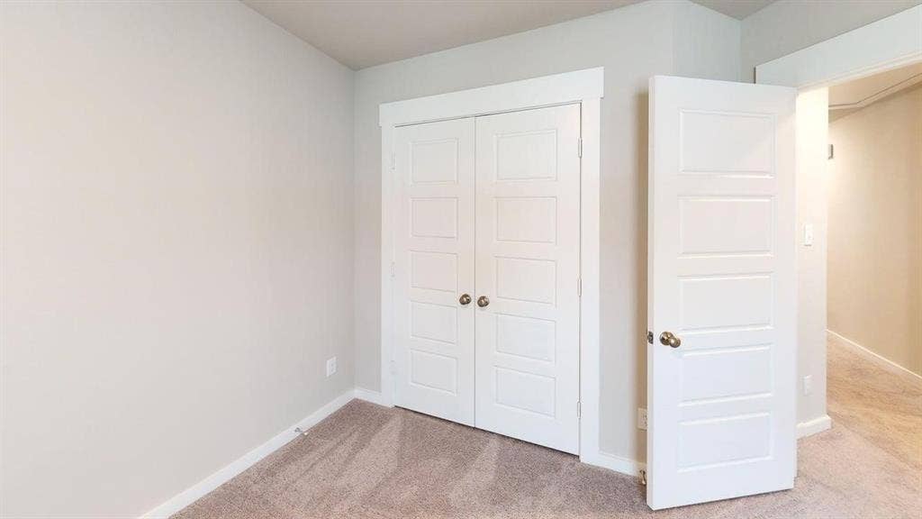 Neutral-toned walls complement plush carpeting