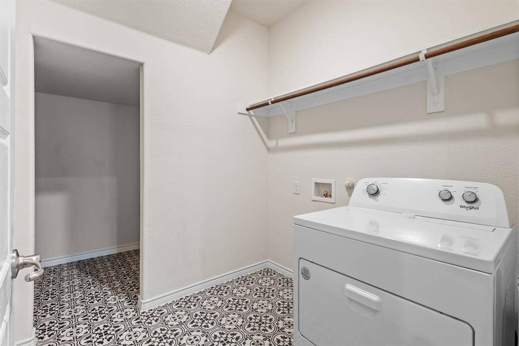1536 Estivella Drive, Little Elm, TX 75068 Utility area featuring patterned tile flooring, built-in shelving, and a clothing rod