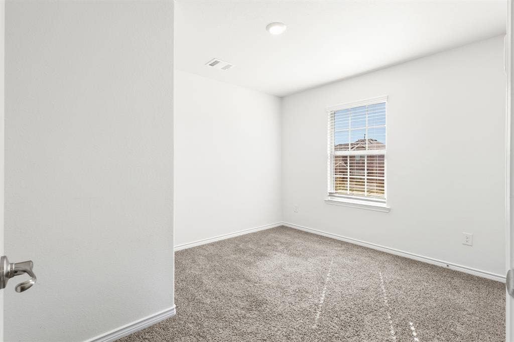1536 Estivella Drive, Little Elm, TX 75068 Plush carpeting, neutral wall colors, recessed lighting, and a single window with blinds
