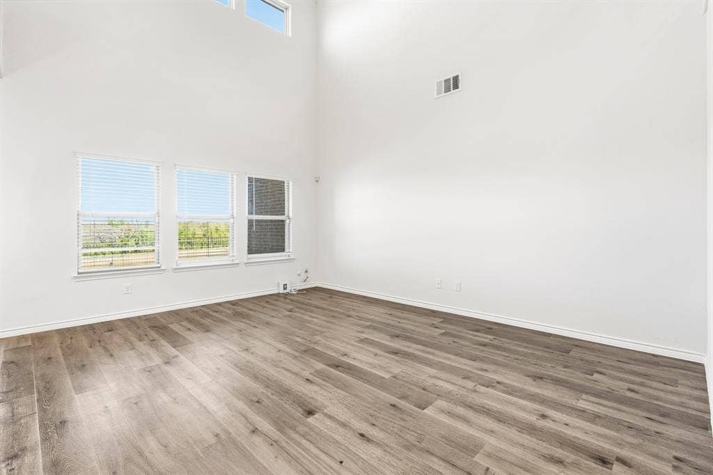 1536 Estivella Drive, Little Elm, TX 75068 High ceilings, wood-finish flooring, white walls, and multiple windows