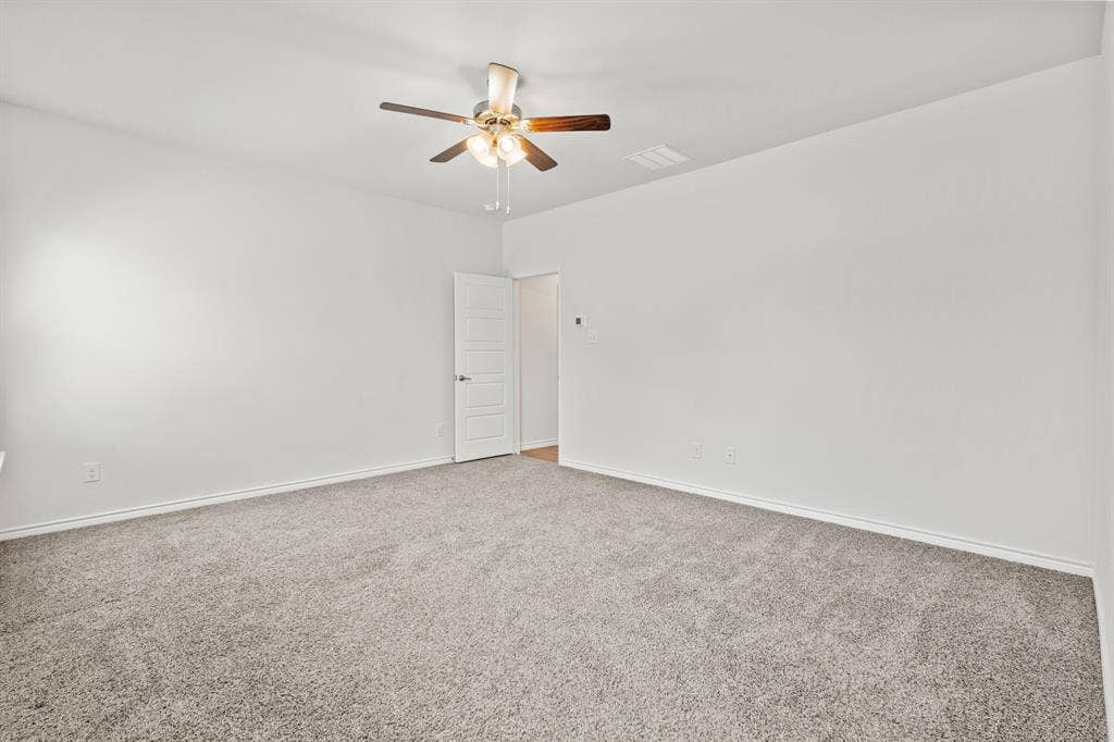 1536 Estivella Drive, Little Elm, TX 75068 Neutral-toned carpeting, white walls, and a ceiling fan with integrated lighting