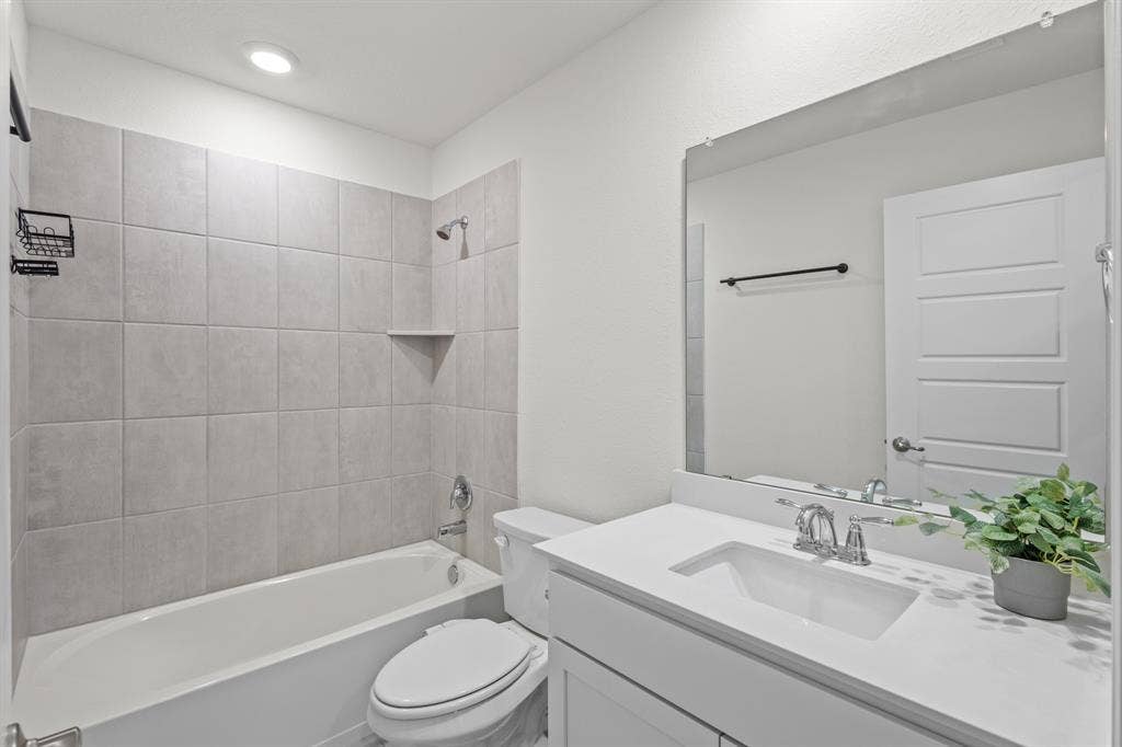 1536 Estivella Drive, Little Elm, TX 75068 Built-in bathtub with light gray tile surround and recessed shelf