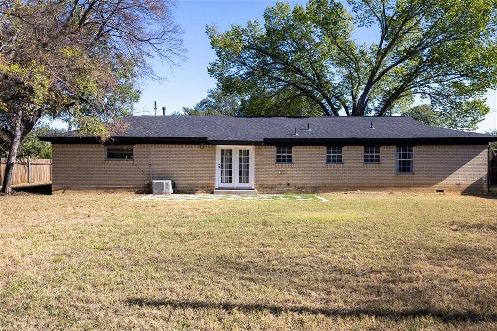 5920 Tourist Drive, North Richland Hills, TX 76117 Back of house with patio and large, fenced backyard.