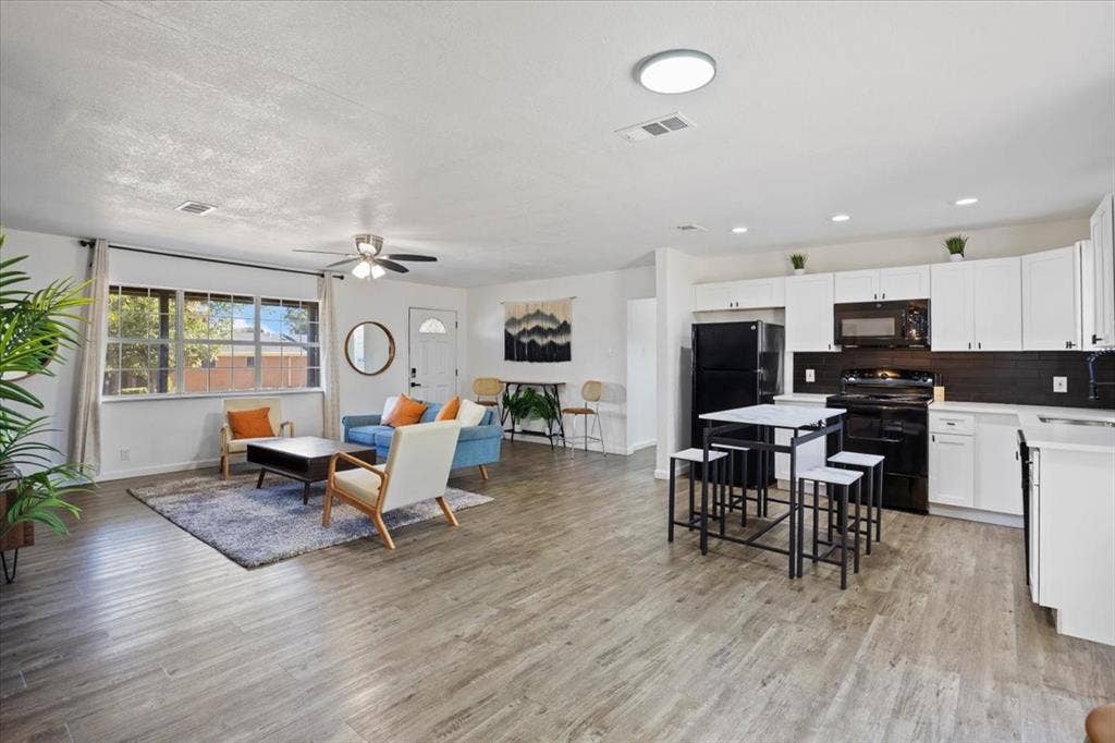5920 Tourist Drive, North Richland Hills, TX 76117 Living room opens to the kitchen with breakfast area.