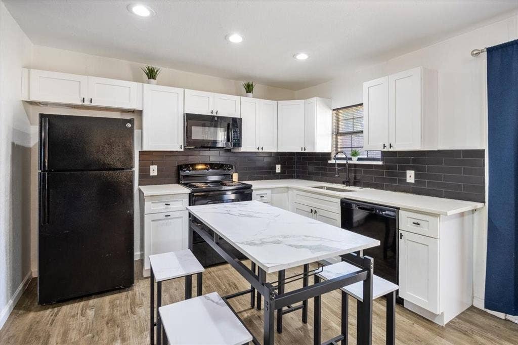 5920 Tourist Drive, North Richland Hills, TX 76117 Kitchen with white cabinets and subway tile backsplash.
