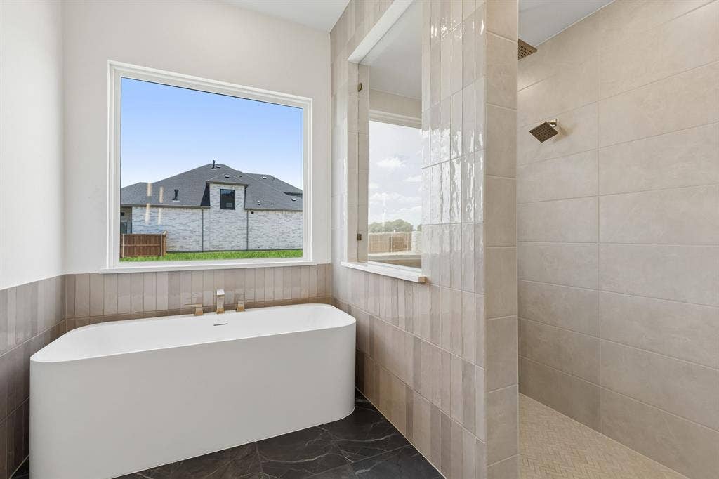 Whether it's soaking your cares away or indulging in a long, luxurious shower, this owner's bath is the perfect place to start or end your day.