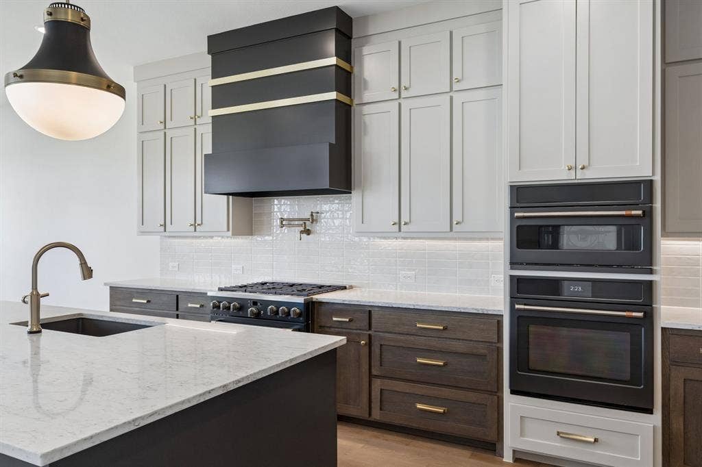 Featuring a striking mix of light and dark cabinets plus modern black stainless steel appliances, any chef would be proud to call this dream kitchen their own!