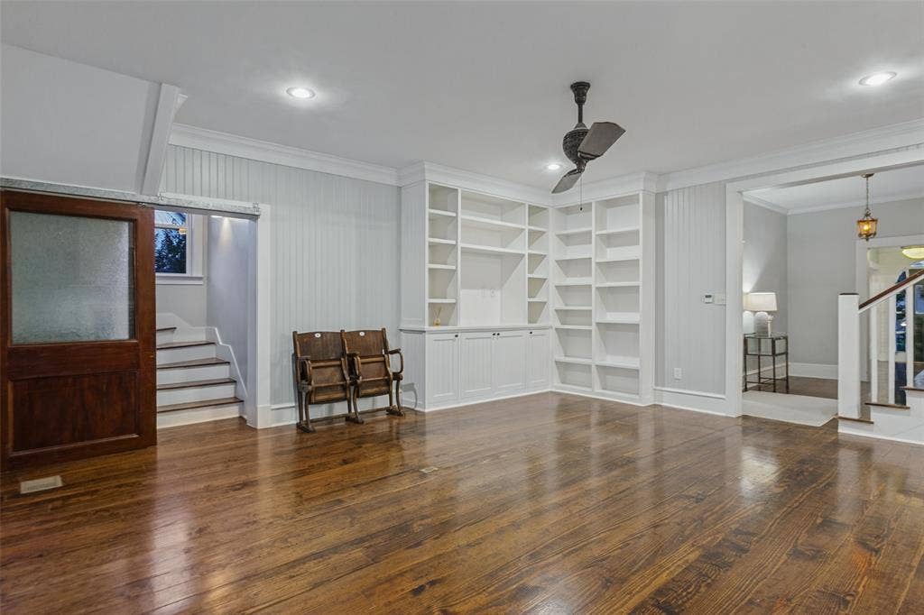 506 W Virginia Street, McKinney, TX 75069 View of living room with built-in shelving, second staircase leading to primary bedroom