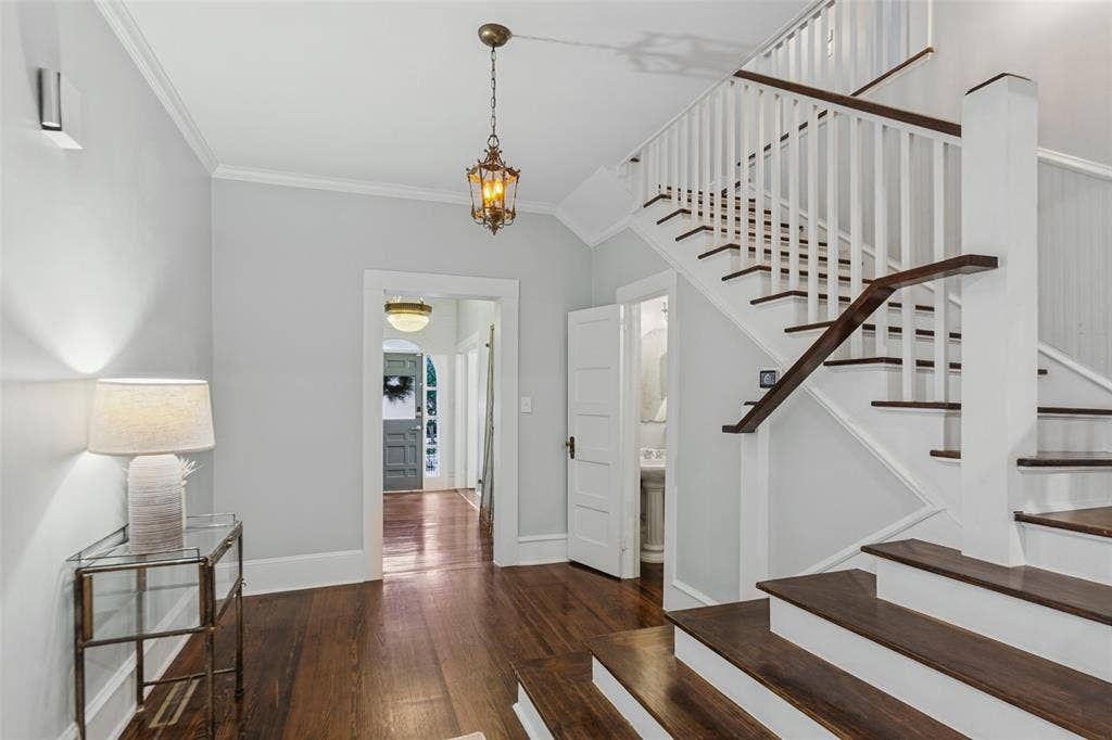 506 W Virginia Street, McKinney, TX 75069 View of front door, entryway and main staircase. Adorable half bathroom located under the staircase