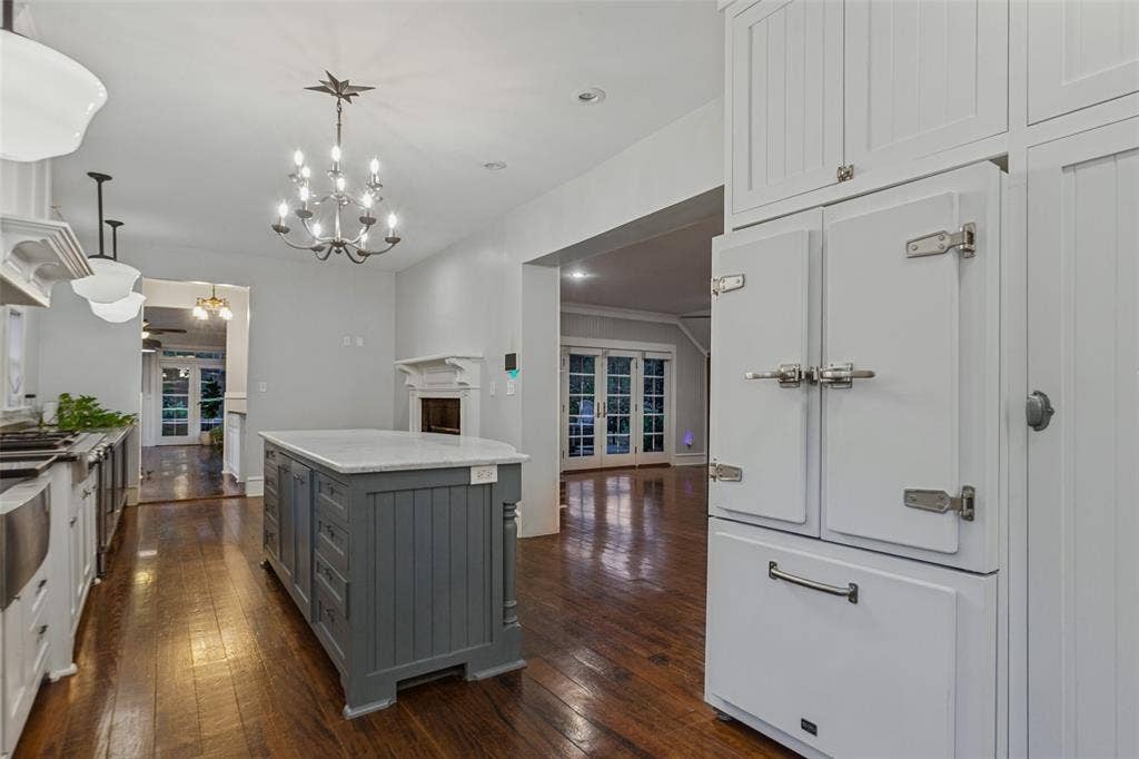 506 W Virginia Street, McKinney, TX 75069 View of kitchen showing view into two living areas, with custom made refrigerator