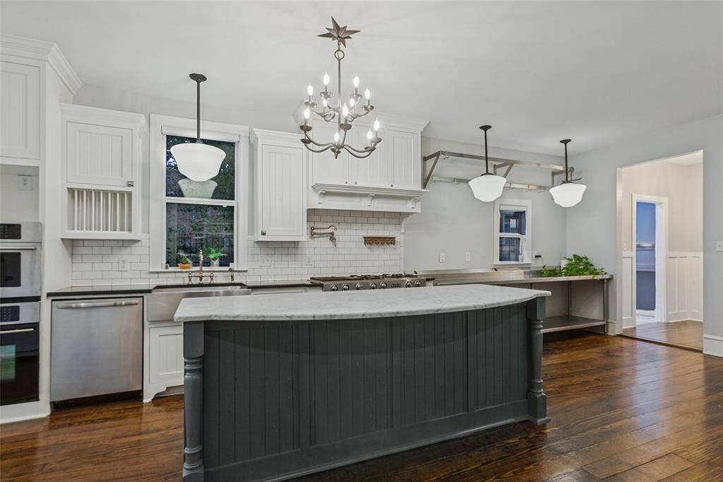 506 W Virginia Street, McKinney, TX 75069 View of kitchen from living room with subway tile, stainless steel appliances, gas range, and commercial grade prep station