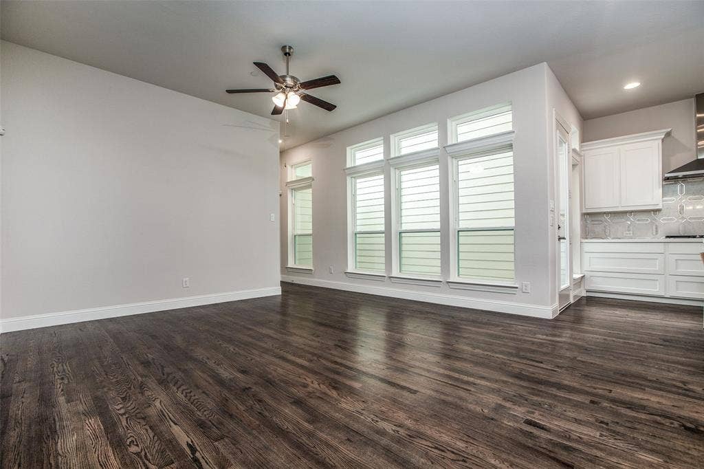 4944 Mckinney Hollow Drive, McKinney, TX 75070 Wood-finish flooring, multiple windows, recessed lighting, ceiling fan, white cabinetry