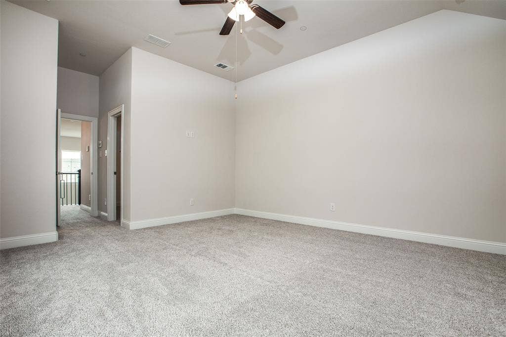 4944 Mckinney Hollow Drive, McKinney, TX 75070 Spacious room with light neutral carpet, a ceiling fan with integrated lighting, and neutral wall paint