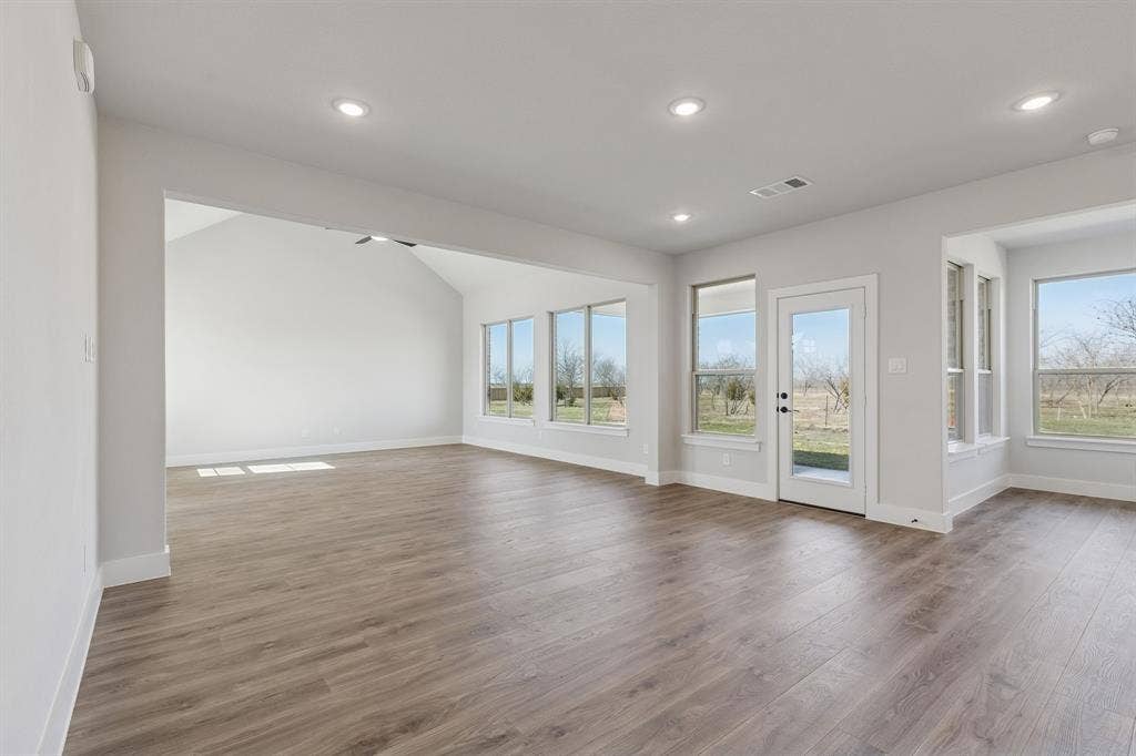 410 Rancher Trail, Waxahachie, TX 75165 Wood-finish flooring throughout, recessed lighting, and a vaulted ceiling