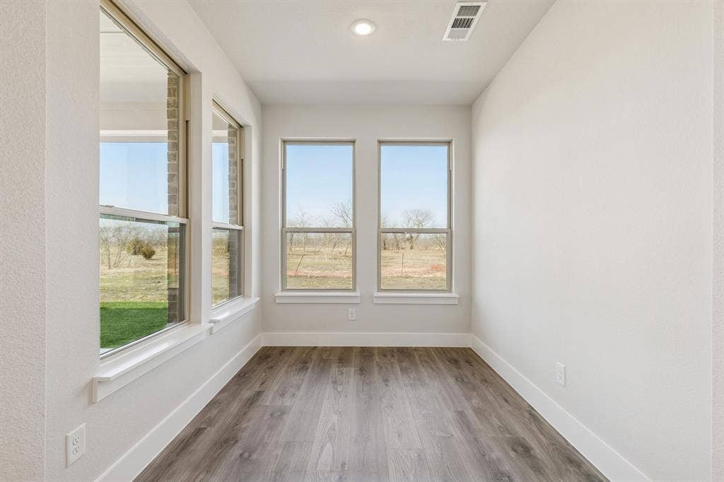 410 Rancher Trail, Waxahachie, TX 75165 Multiple windows, wood-finish flooring, recessed lighting, and white walls